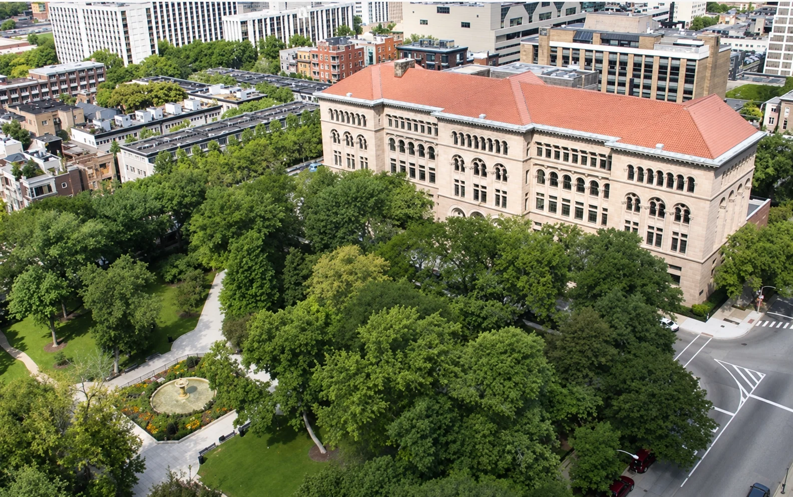 Aerial view of Newberry Library with its red roof and surrounding trees